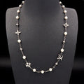 A silver-tone chain necklace with white faux pearls and Louis Vuitton monogram and floral motifs, displayed on a black mannequin bust against a black background.